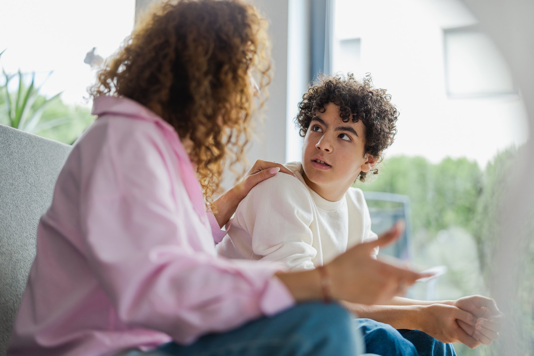 Mother and son arguing with each other at home