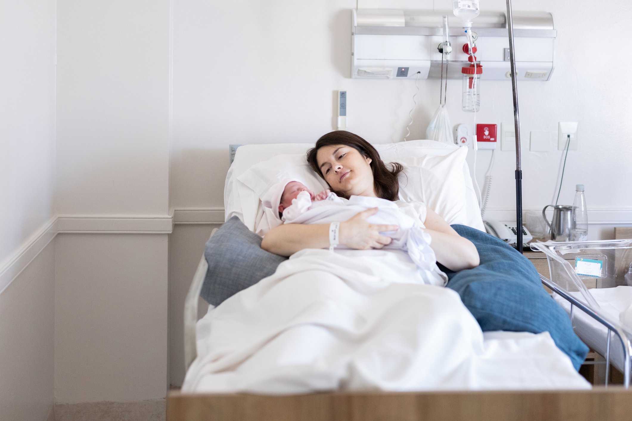 Mother holding her newborn baby at hospital after cesarean section Mother holding her newborn baby at hospital after cesarean section- Buenos Aires - Argentina