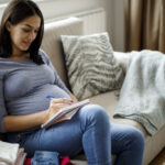 Pregnant woman making notes
