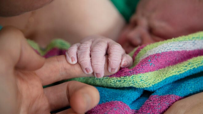 Cropped Hand Of Newborn Baby Holding Finger, unassisted home birth, home birth