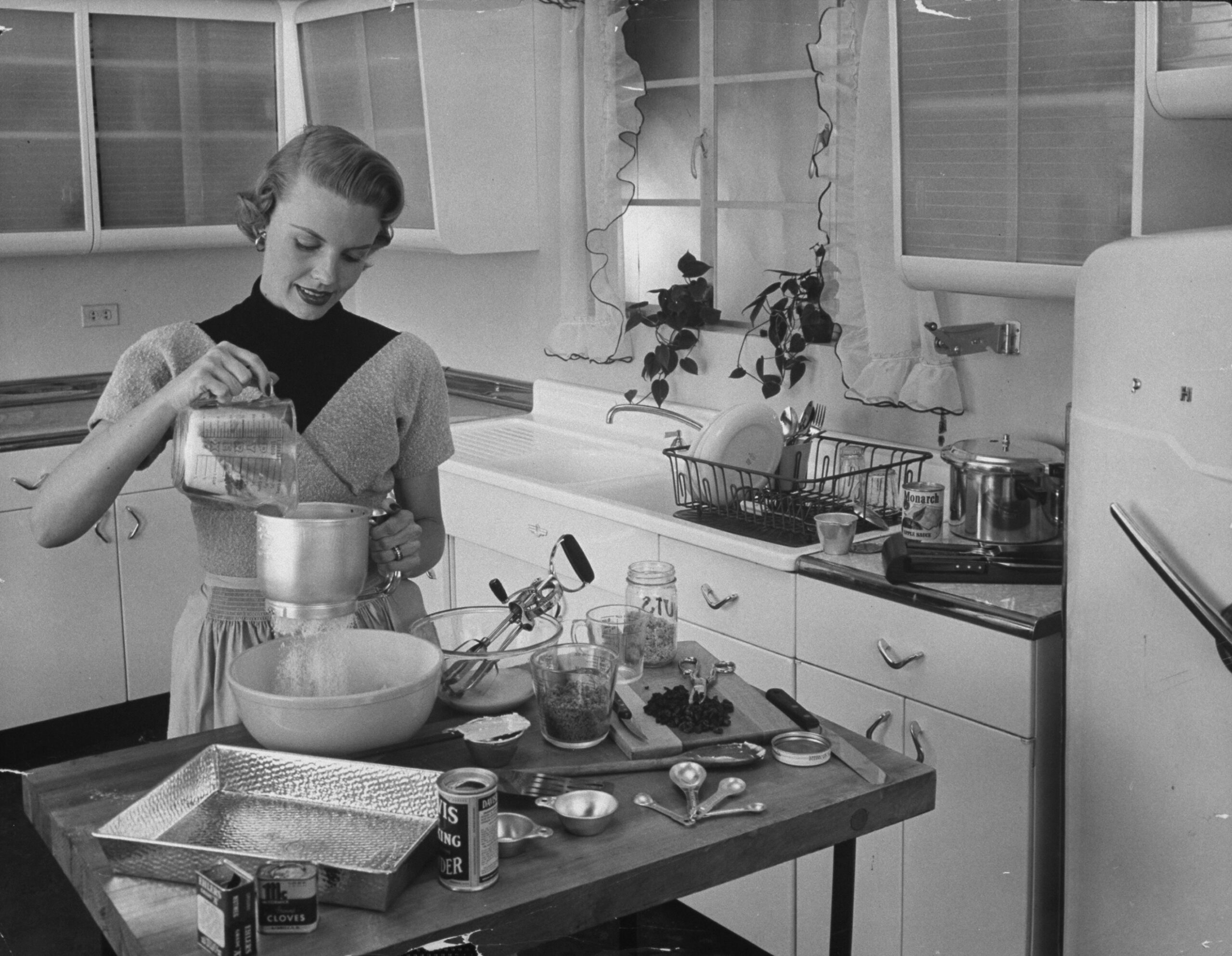 Attractive housewife in modern kitchen,