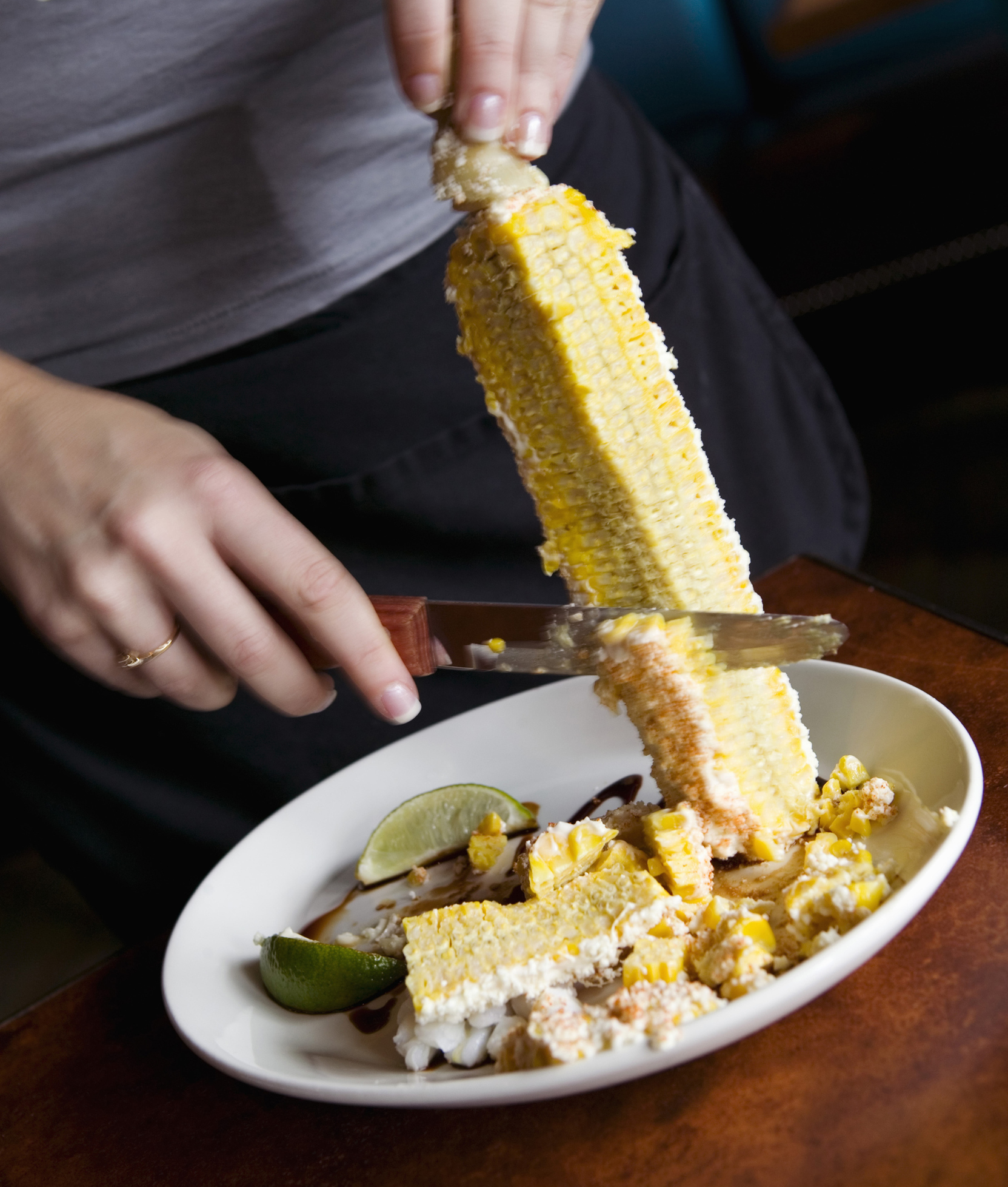 124007-woman-removing-corn-from-cob-2.jpg