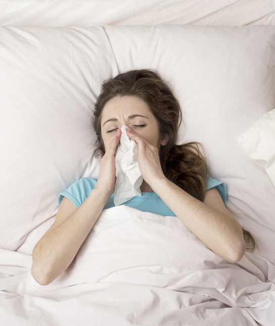 135815-2-woman-sick-in-bed-blowing-her-nose.jpg