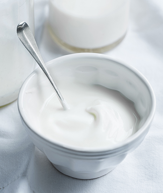Dairy products. Natural yoghurt and milk on a white tablecloth
