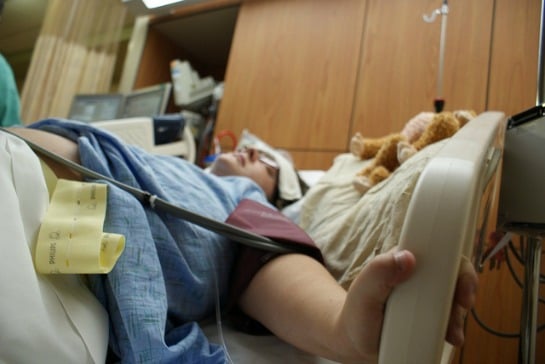 150616-mom-in-hospital-bed-holding-rail-resized.jpg
