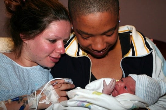 150630-mom-and-dad-looking-at-newborn-resized.jpg