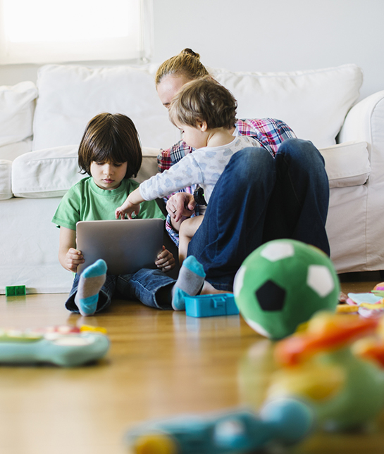 Mother with 2 kids using a digital tablet