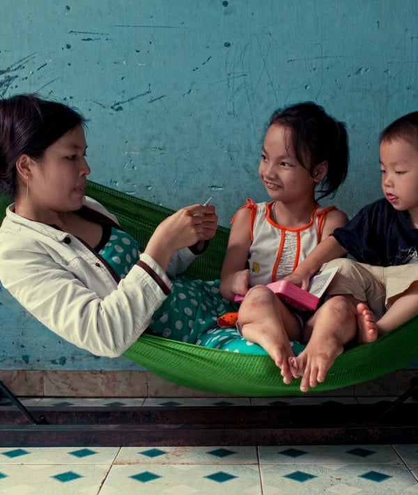 154893-asian-mom-sitting-on-hammock-with-2-kids-resized.jpg