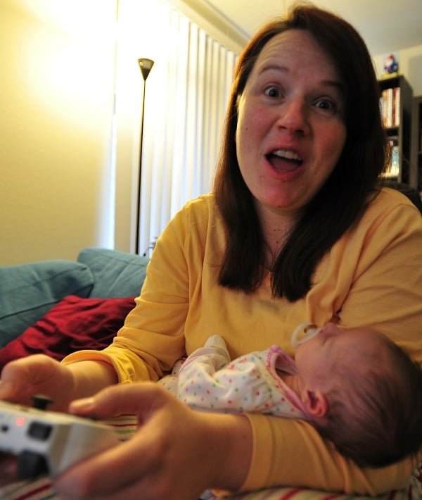 Sleeping babies don't care if Mom is playing video games.
