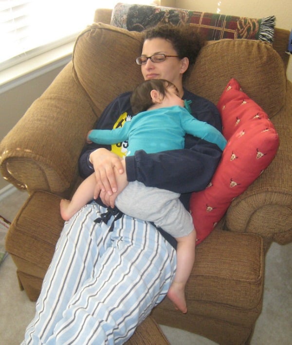 154901-mom-wearing-glasses-laying-down-with-baby-couch-resized.jpg