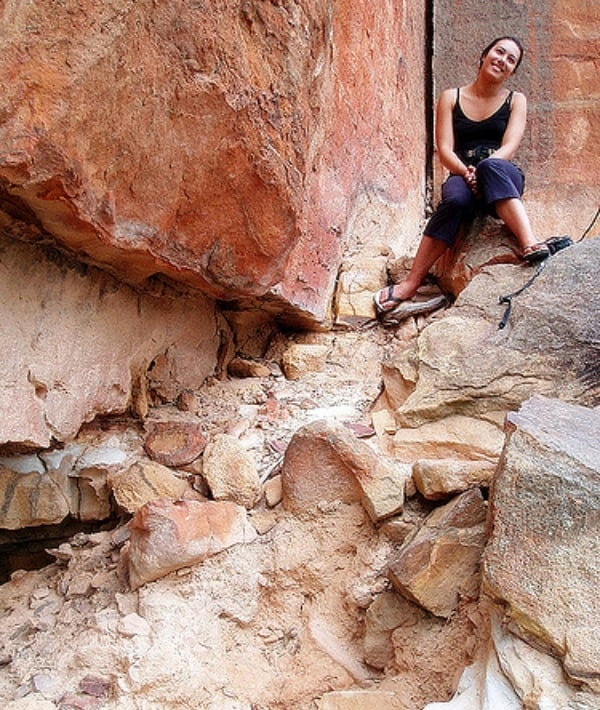 155570-woman-sitting-on-rock-wall.jpg