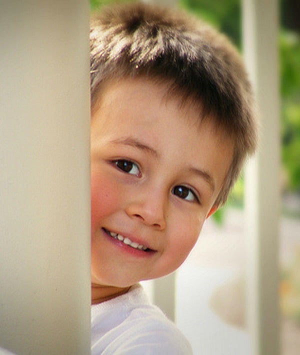 155616-boy-smiling-by-wall.jpg