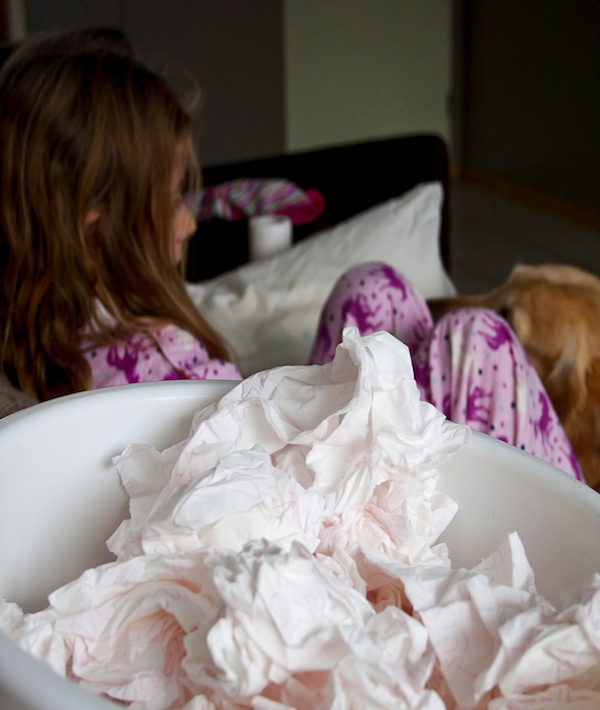 Tissues By Girl Lying In Bedroom