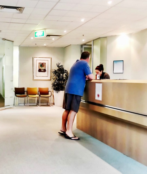 168371-man-checking-in-at-doctor.jpg