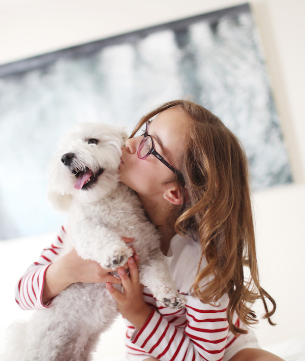 A 10 years old girl kissing her dog