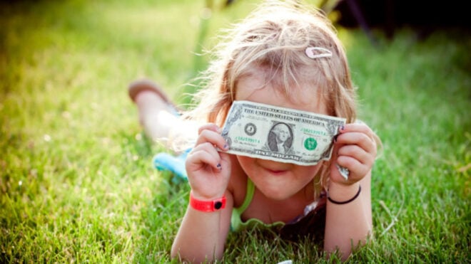 girl-laying-grass-dollar