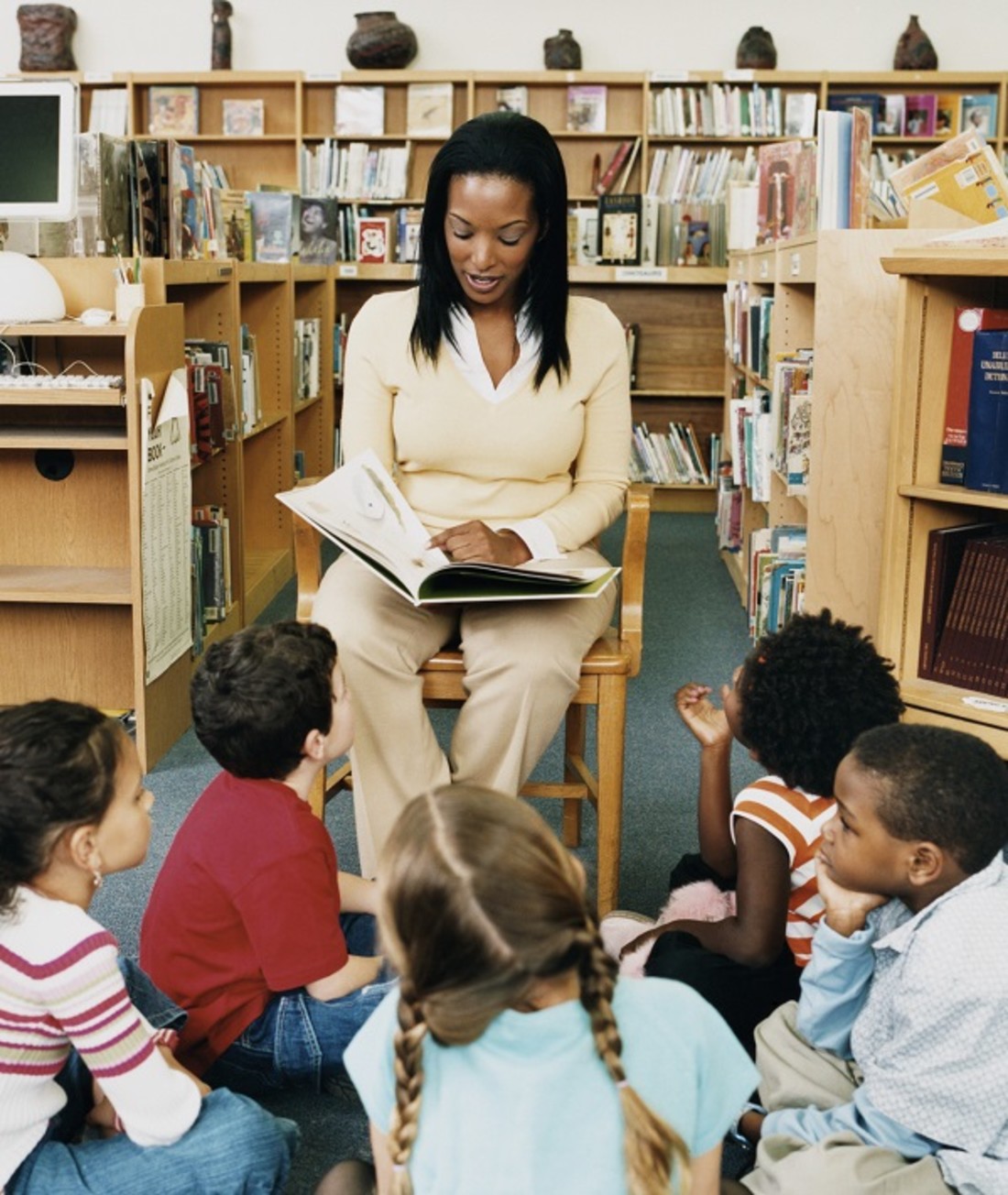 198287-teacher-reading-a-story-book-to-children-in-a-library.jpg