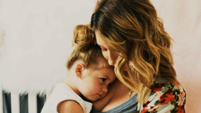mother-cuddling-daughter