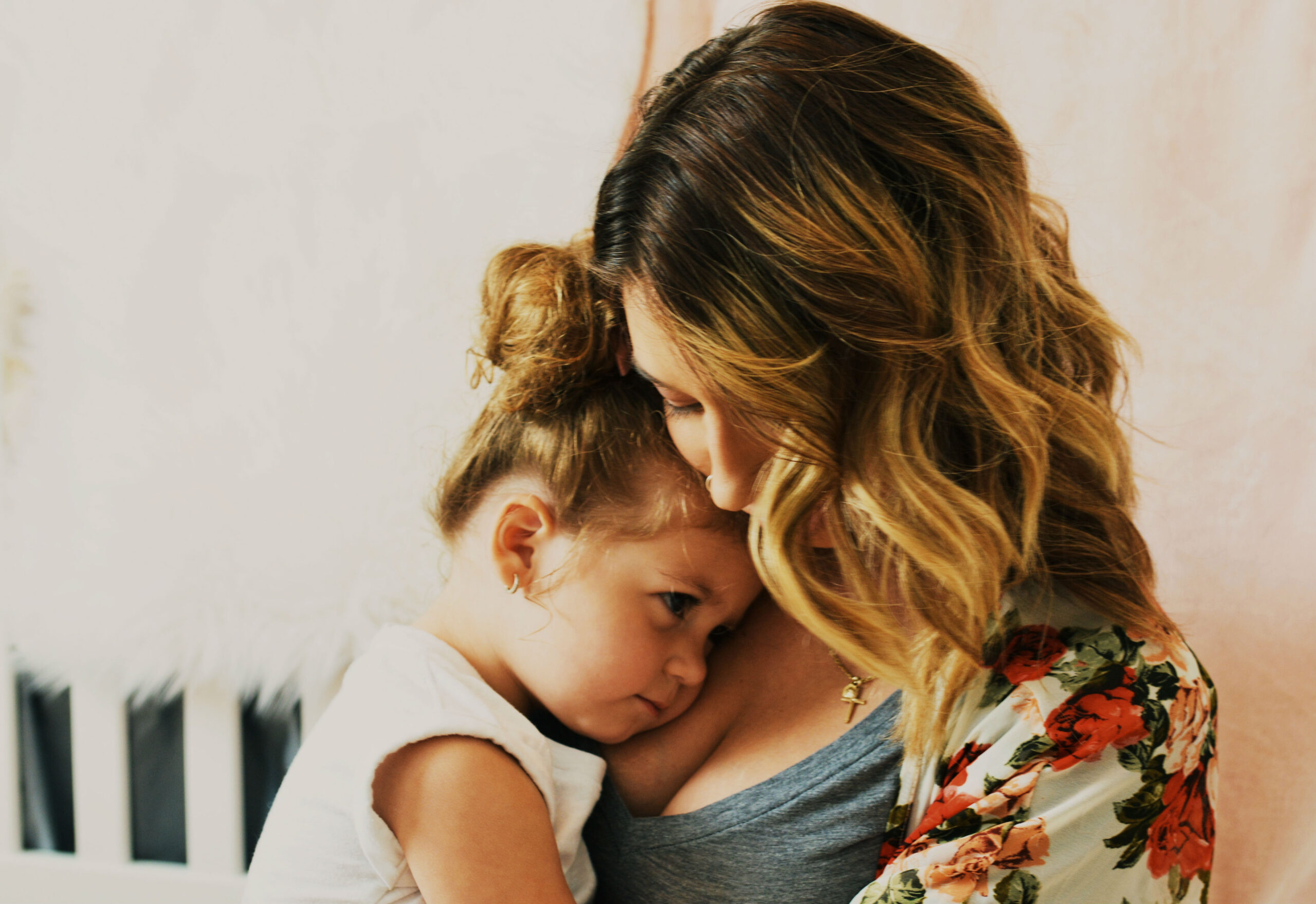 mother-cuddling-daughter