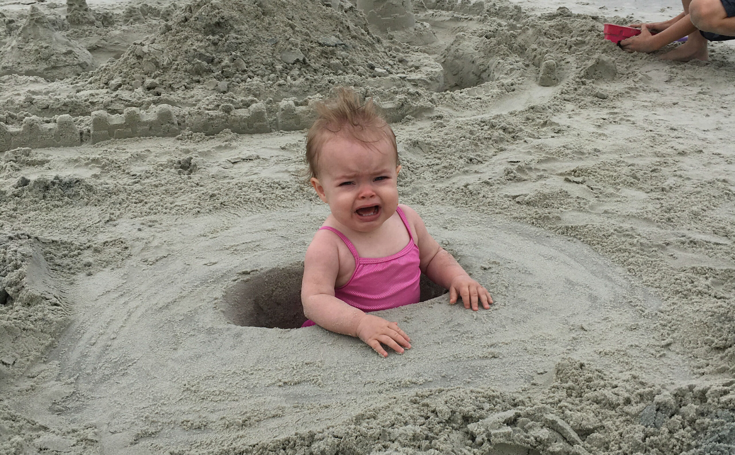 baby-crying-sand
