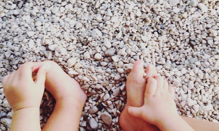 little-girl-holding-feet