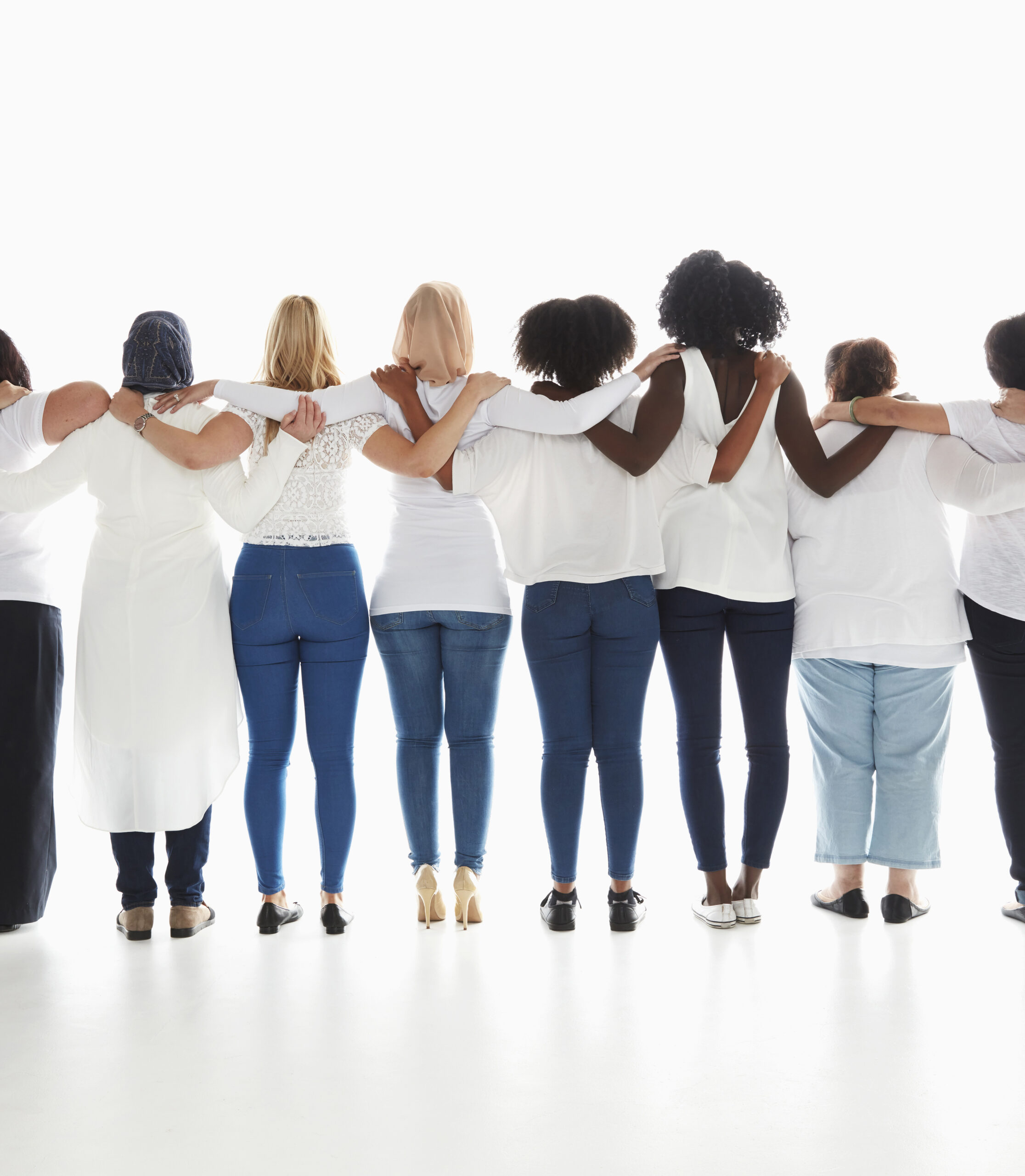 Rear view of diverse women standing in a row hugging