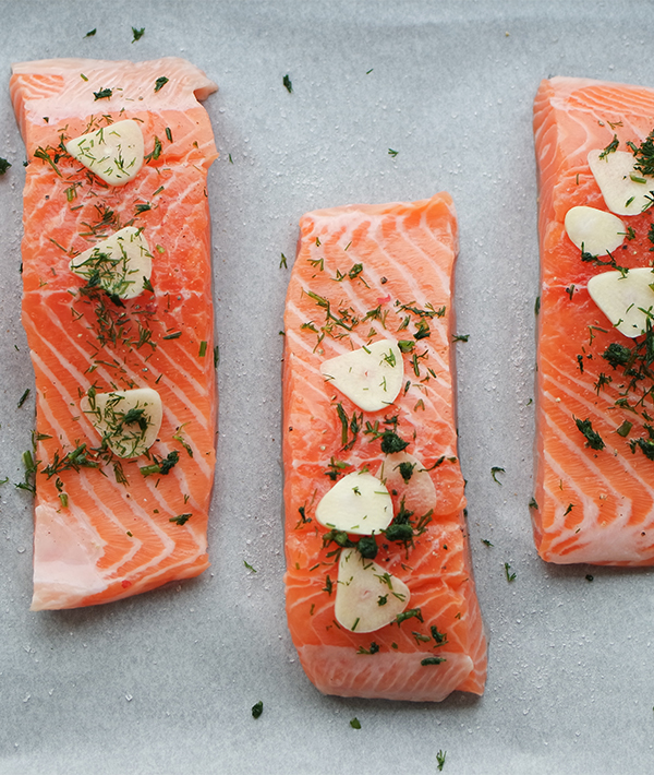 Directly Above Shot Of Salmon Steaks On Paper