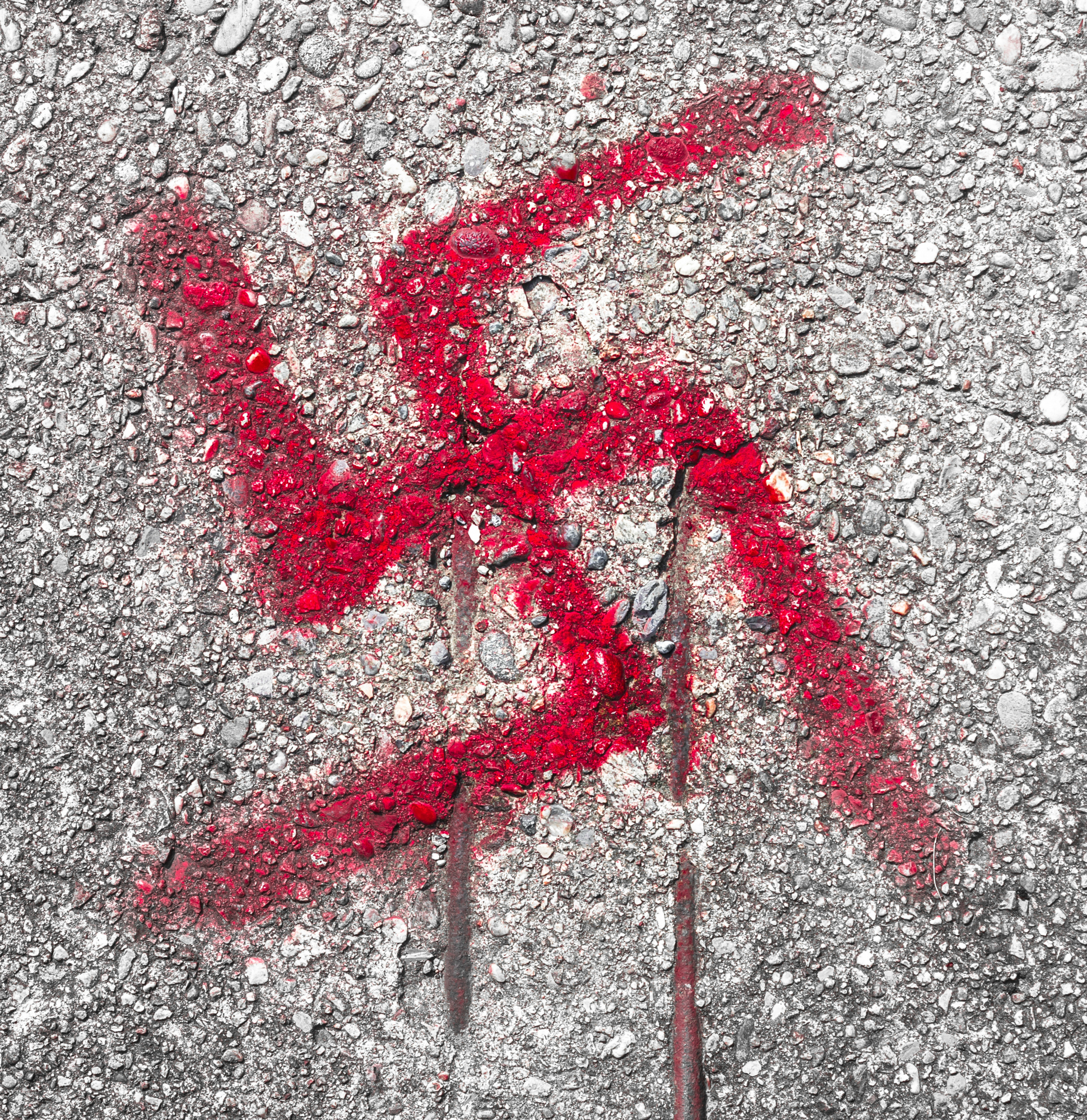 Graffiti on road floor of the svastika symbol.