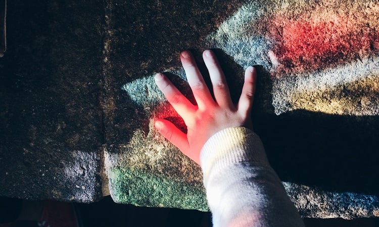 child-hand-church-window-rainbow