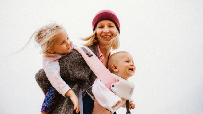 happy-mother-with-her-children-walking-on-the-beach_t20_9l4wqv