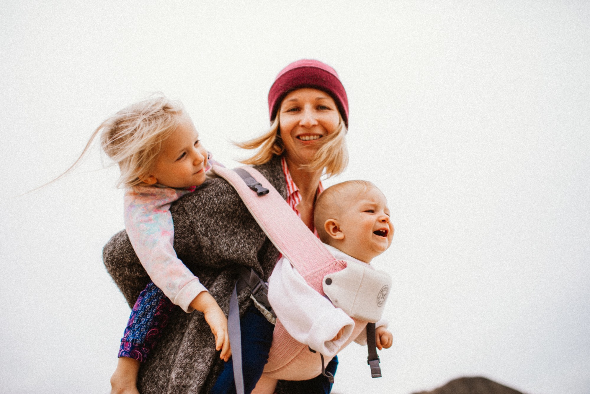 happy-mother-with-her-children-walking-on-the-beach_t20_9l4wqv
