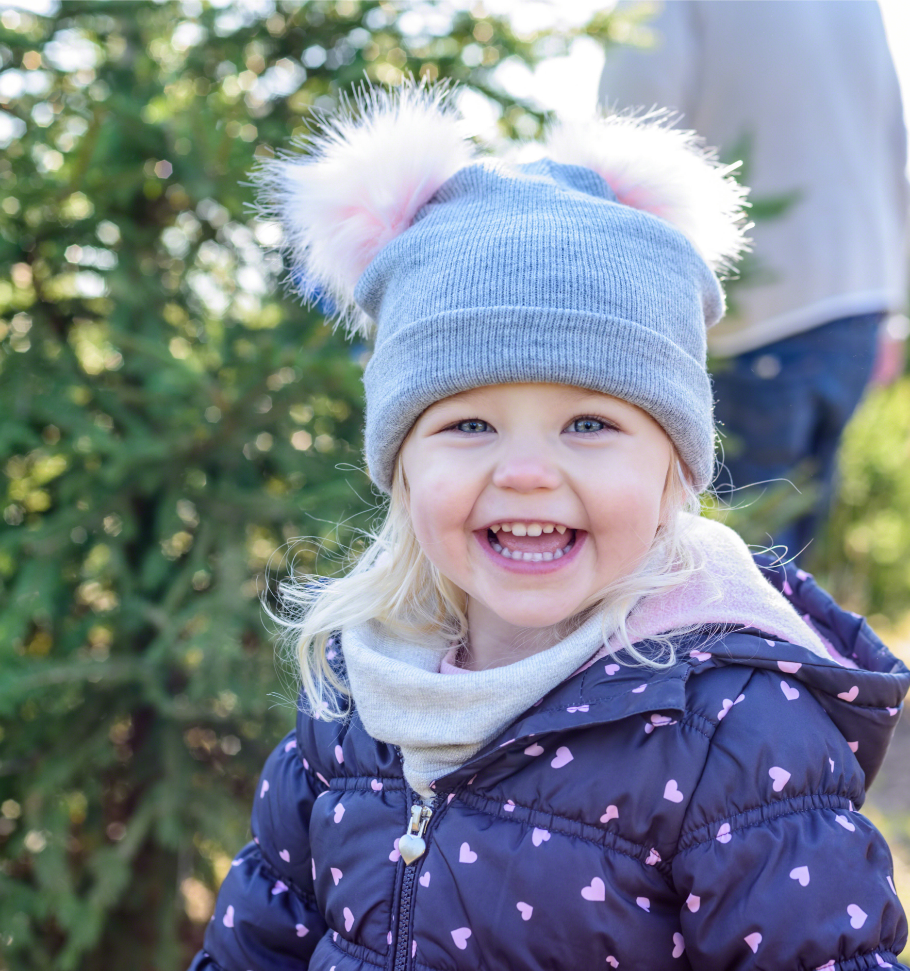 closeup of happy little girl having fun finding a christmas tree in winter