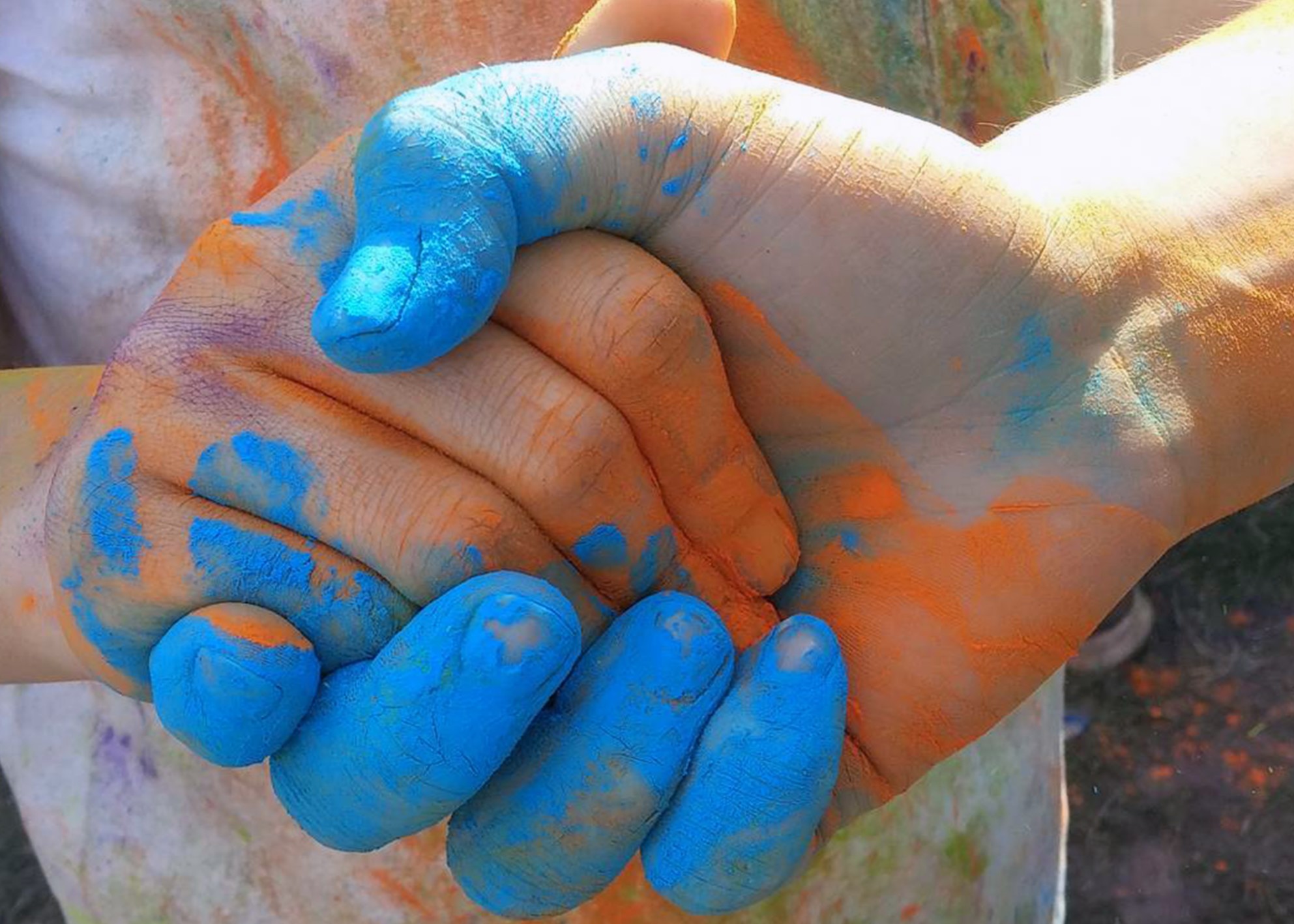 239367-unity-colors-handshake-holi.jpg