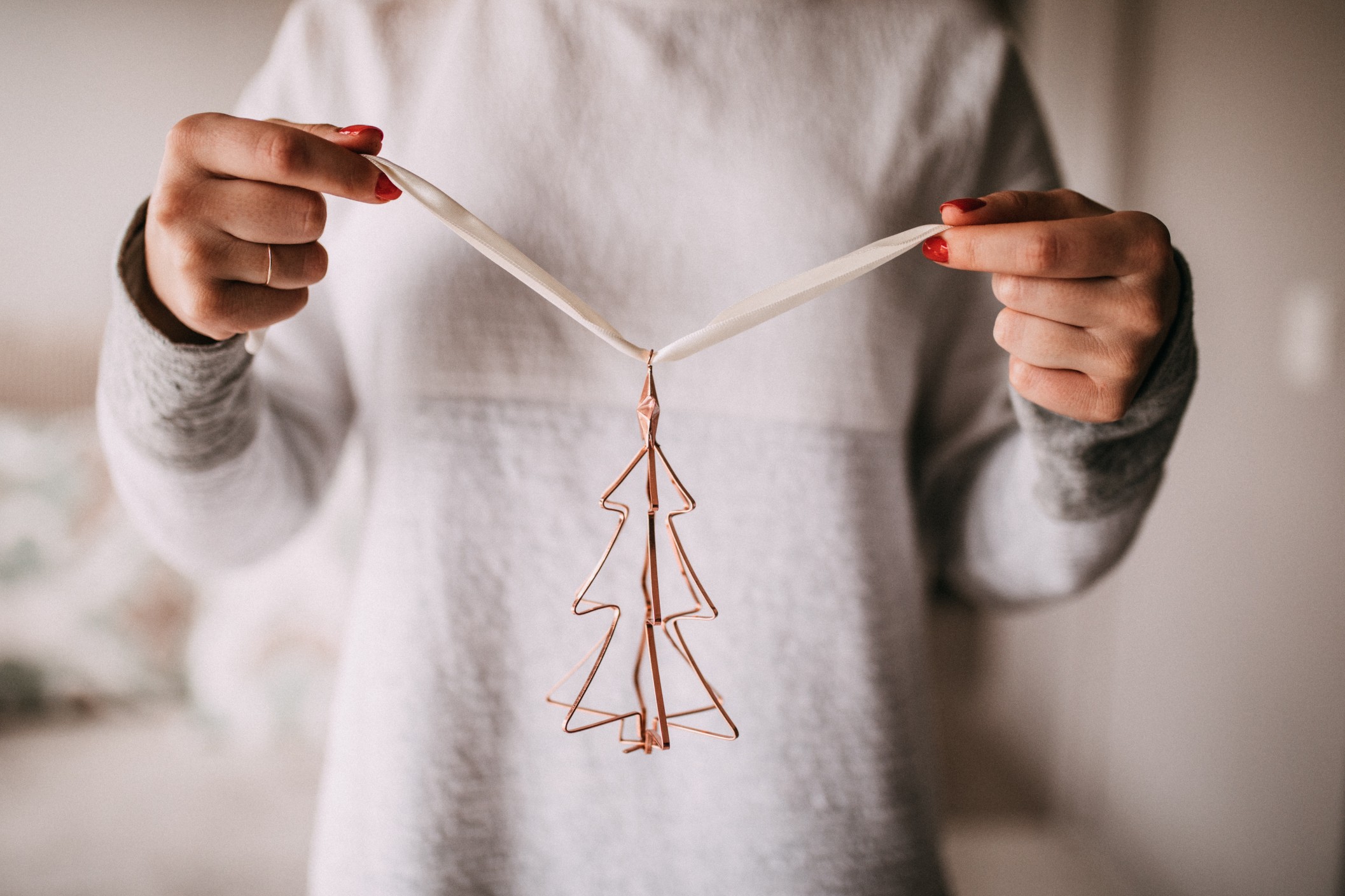 239368-woman-holding-christmas-tree-ornament.jpg