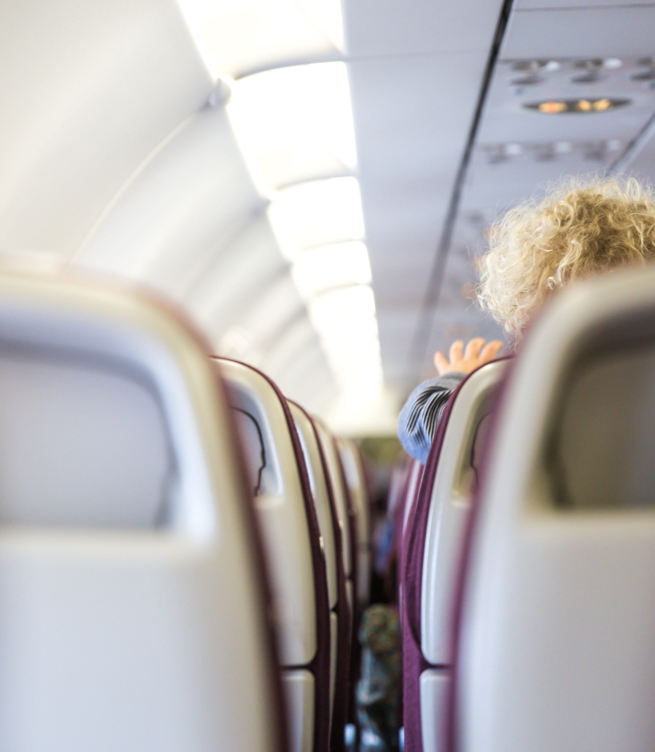 Interior of airplane with children passenger on seats.