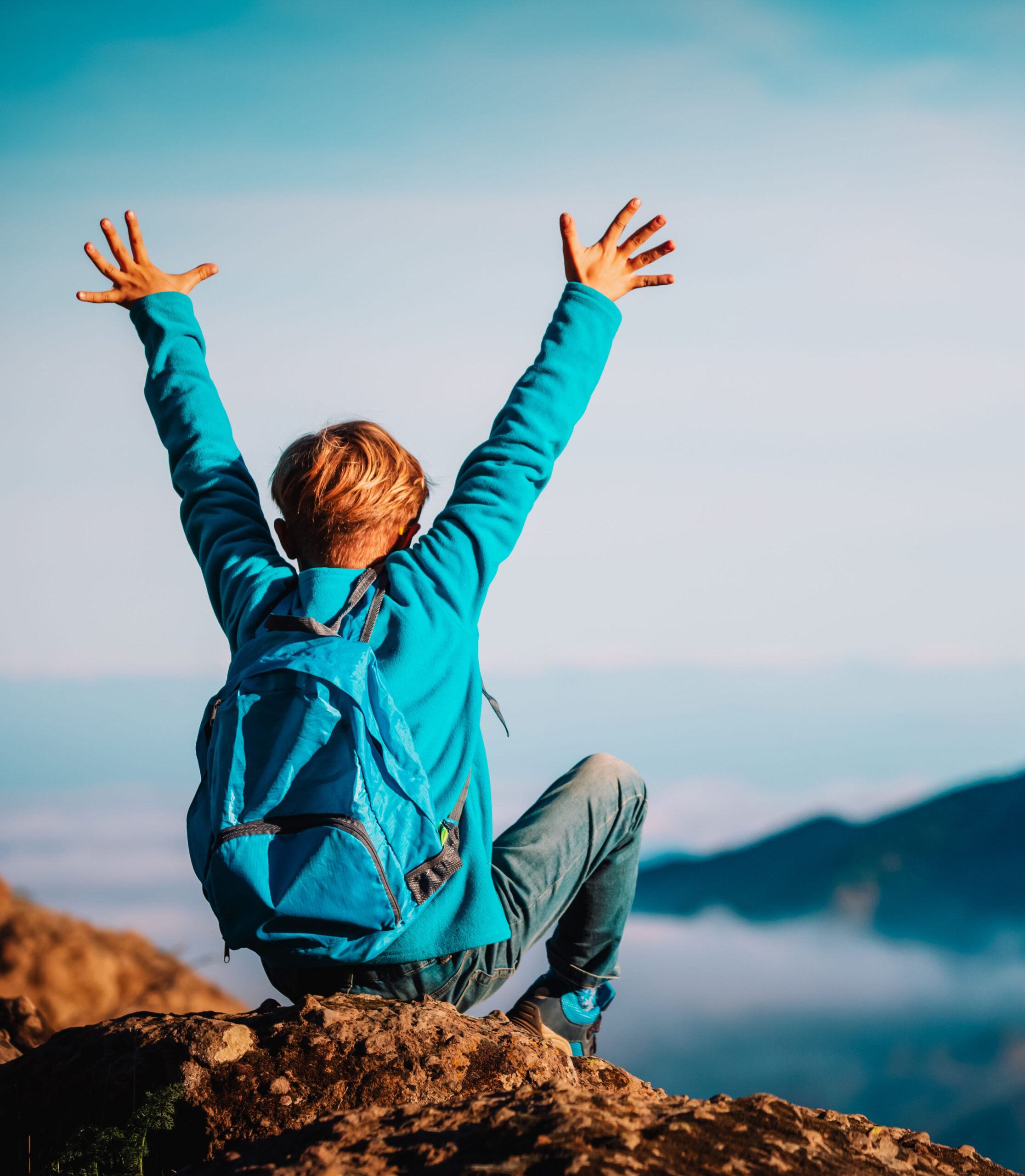 happy young boy enjoy travel hiking in mountains