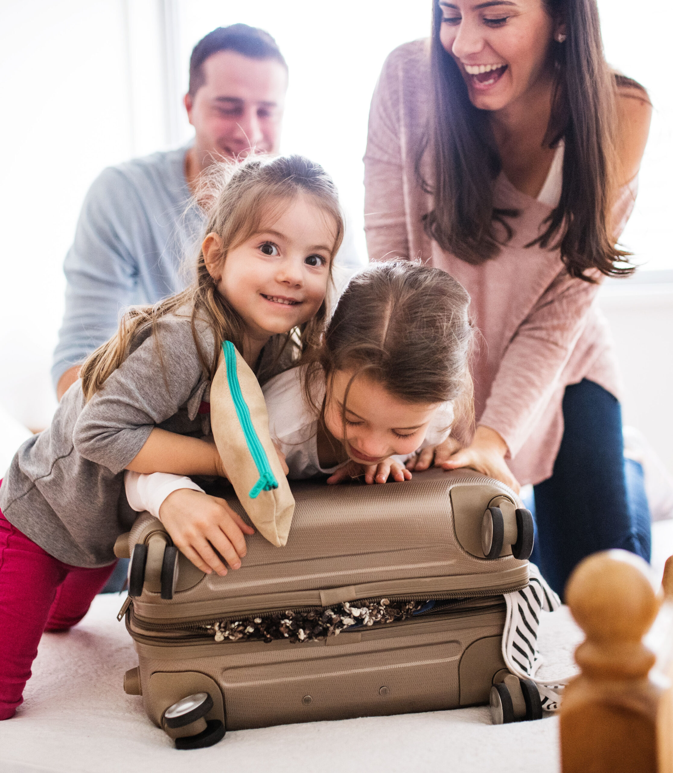 Young family with two children packing for holiday.