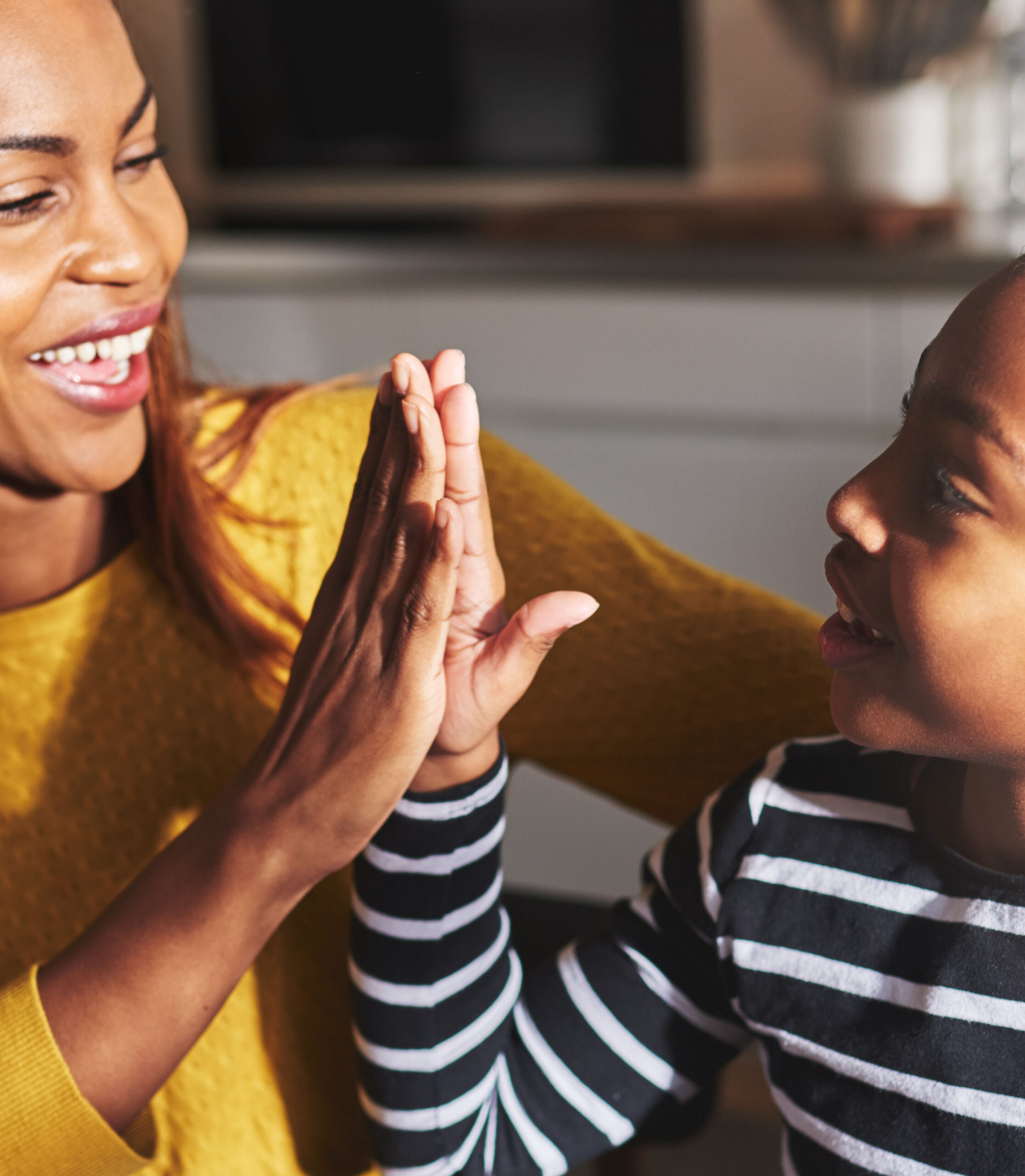 Black mother and child high five