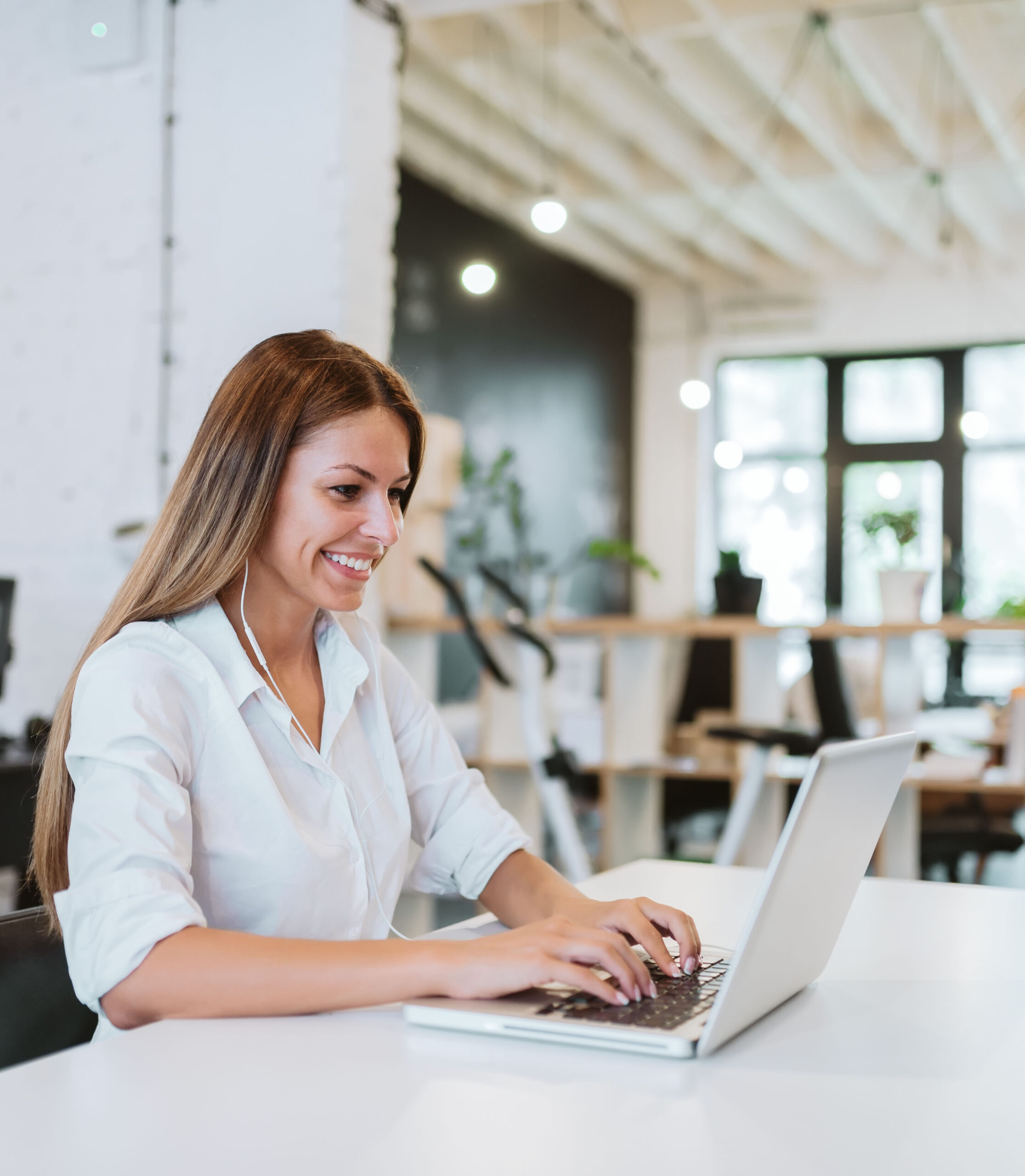 Lovely young woman working in modern co-working office.