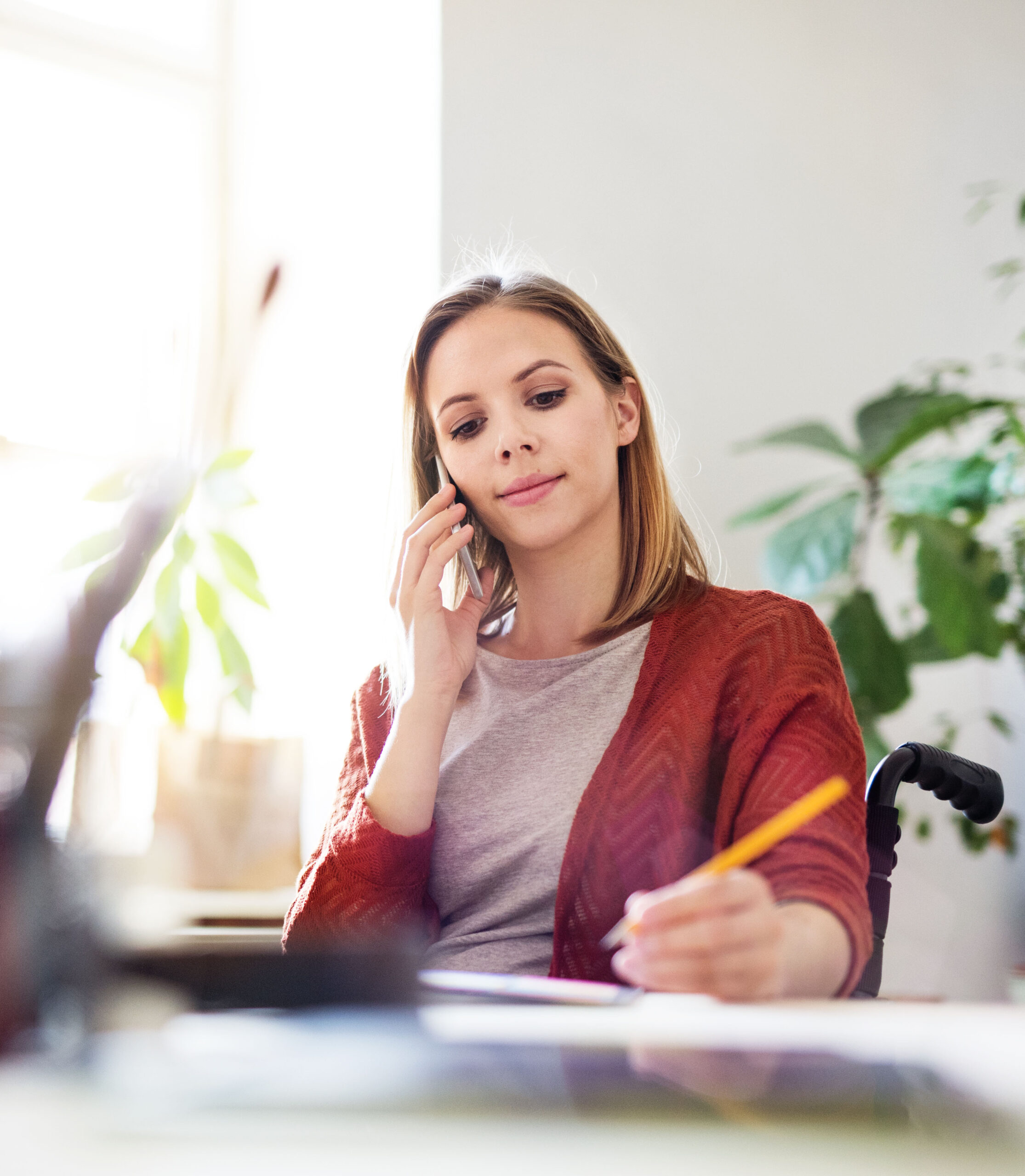 Businesswoman in wheelchair at the desk in her office.