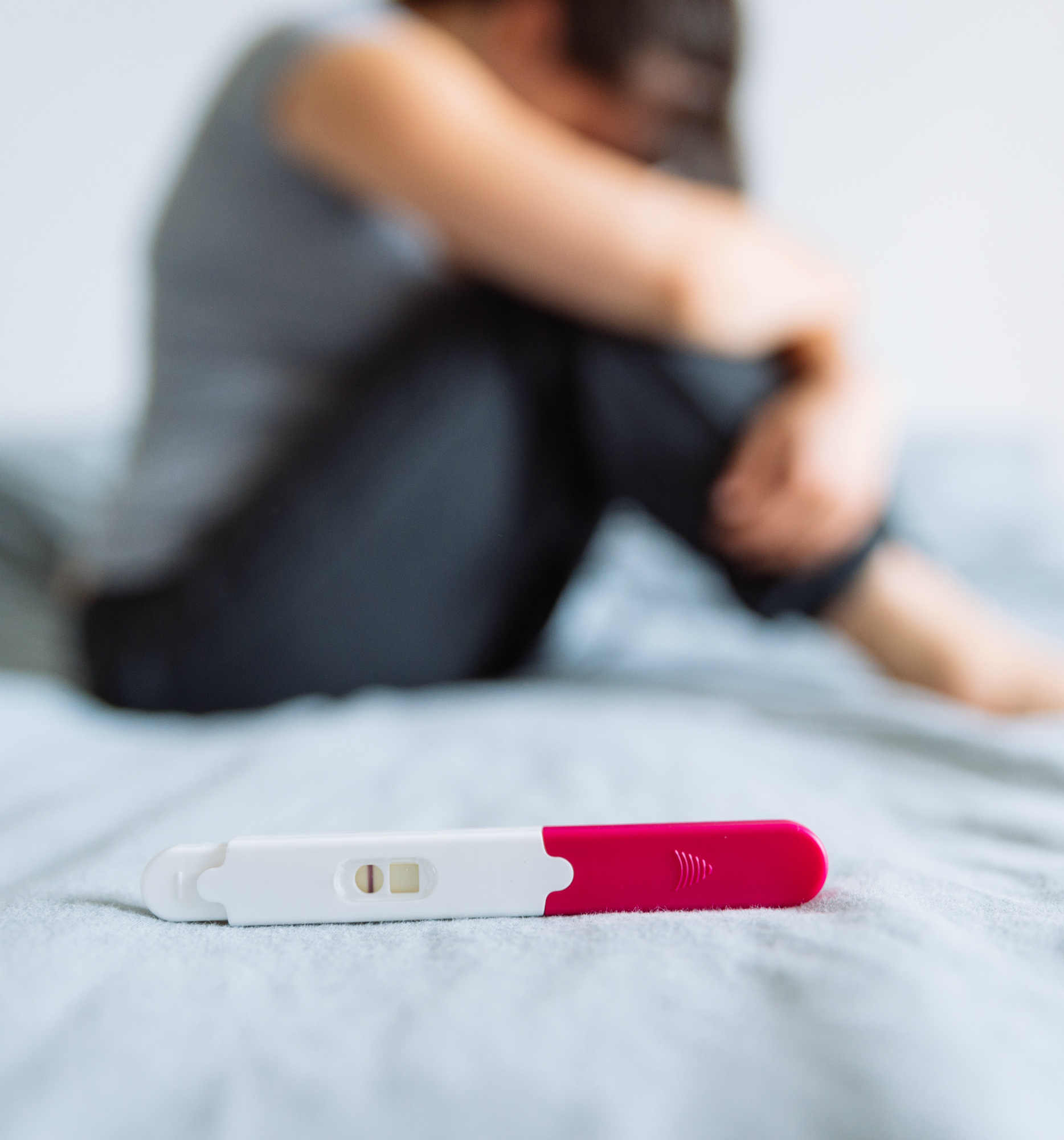 negative pregnancy test. sad woman on background