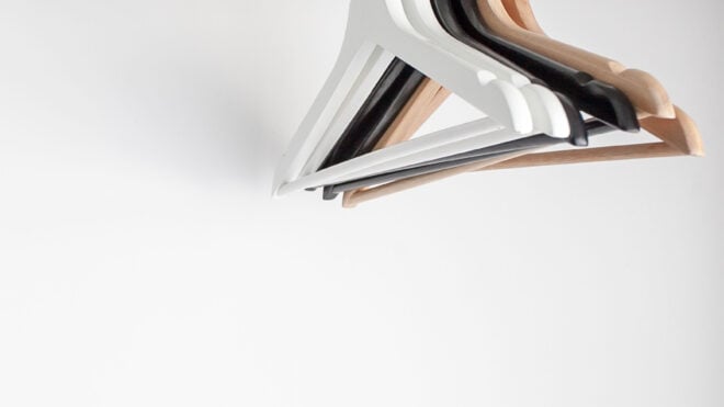 Wooden hangers on white wall background - Wooden hangers on white wall background