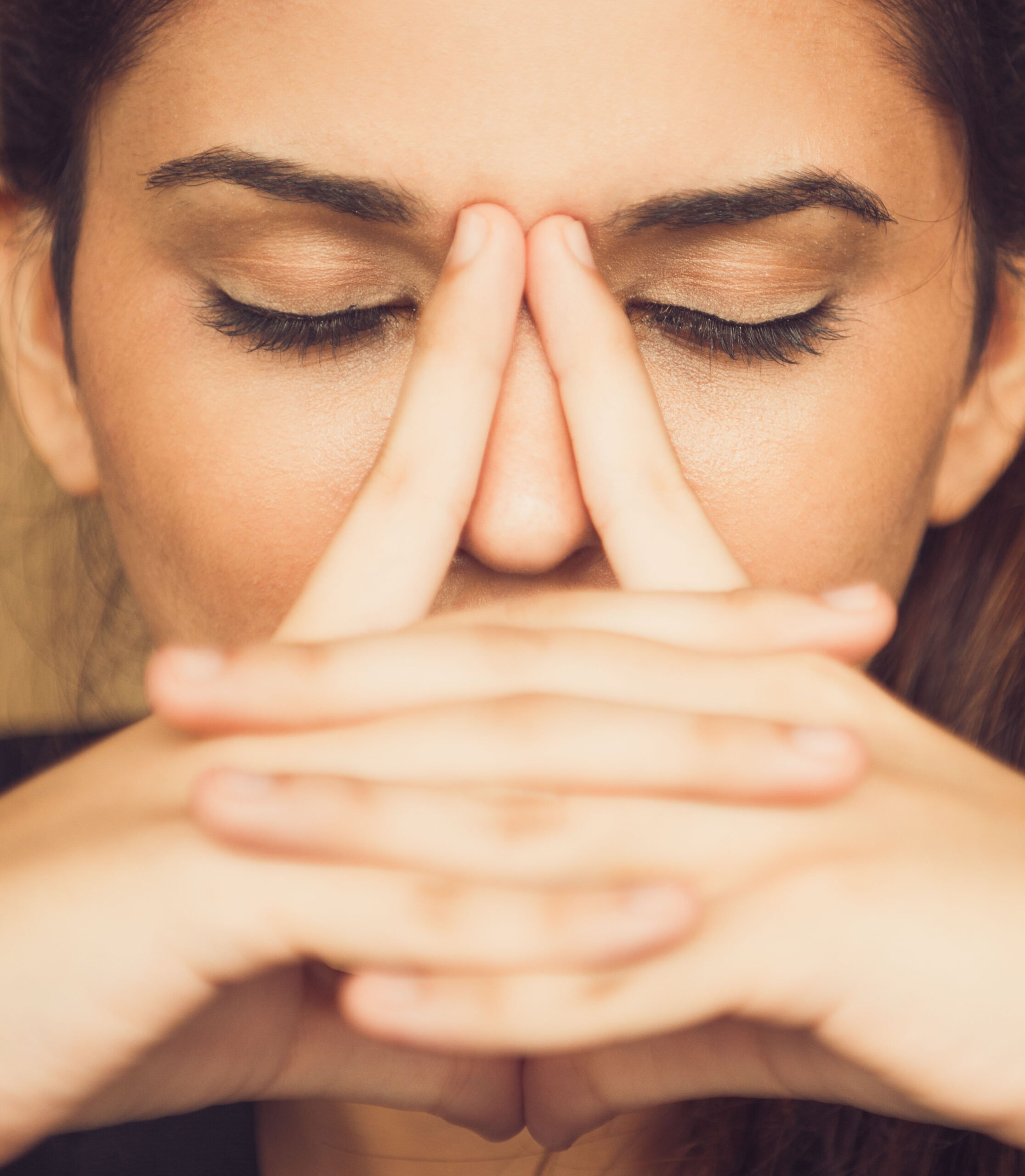 Close-up of tired young woman rubbing nose