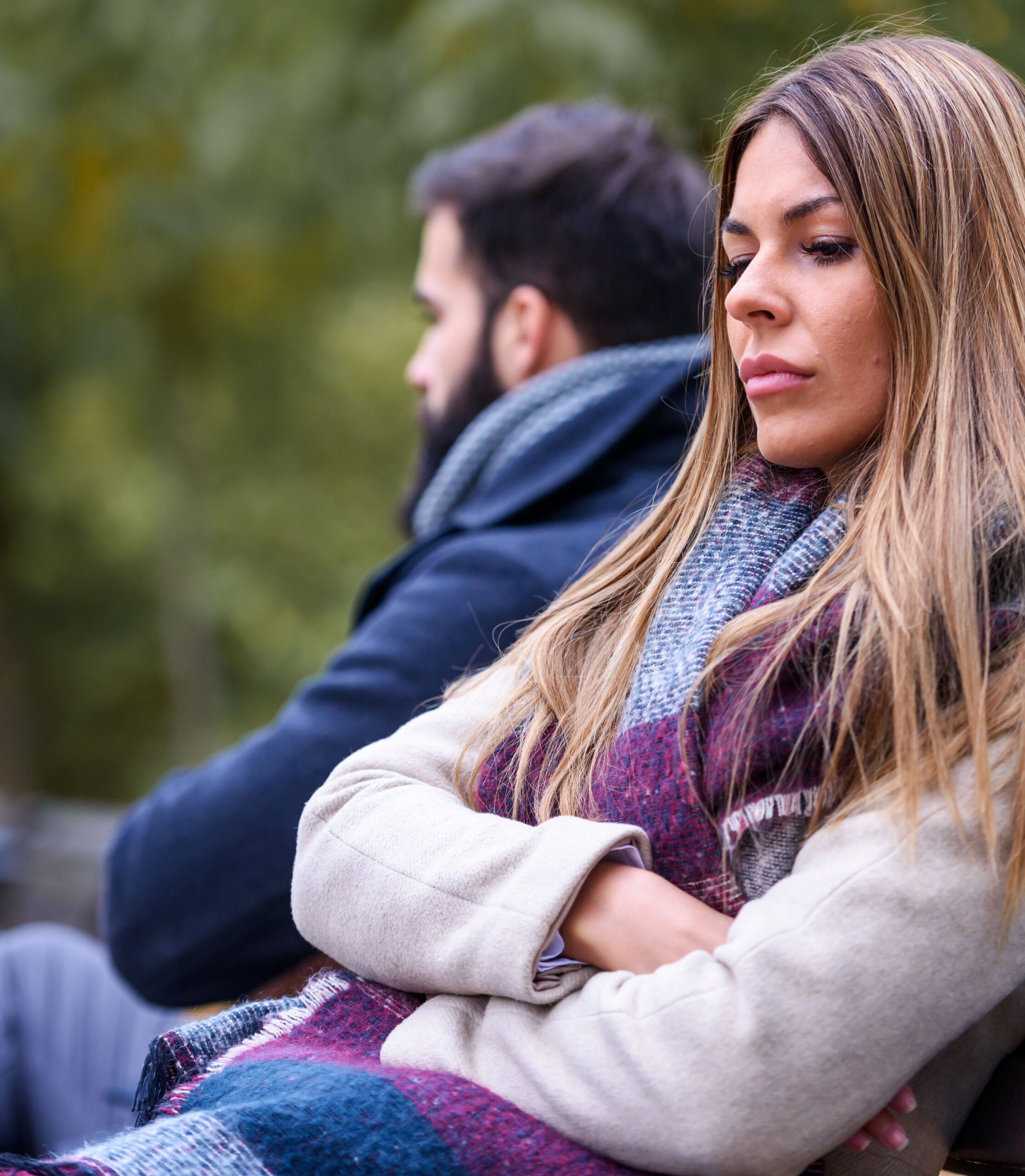Couple sitting in park having relationship problems