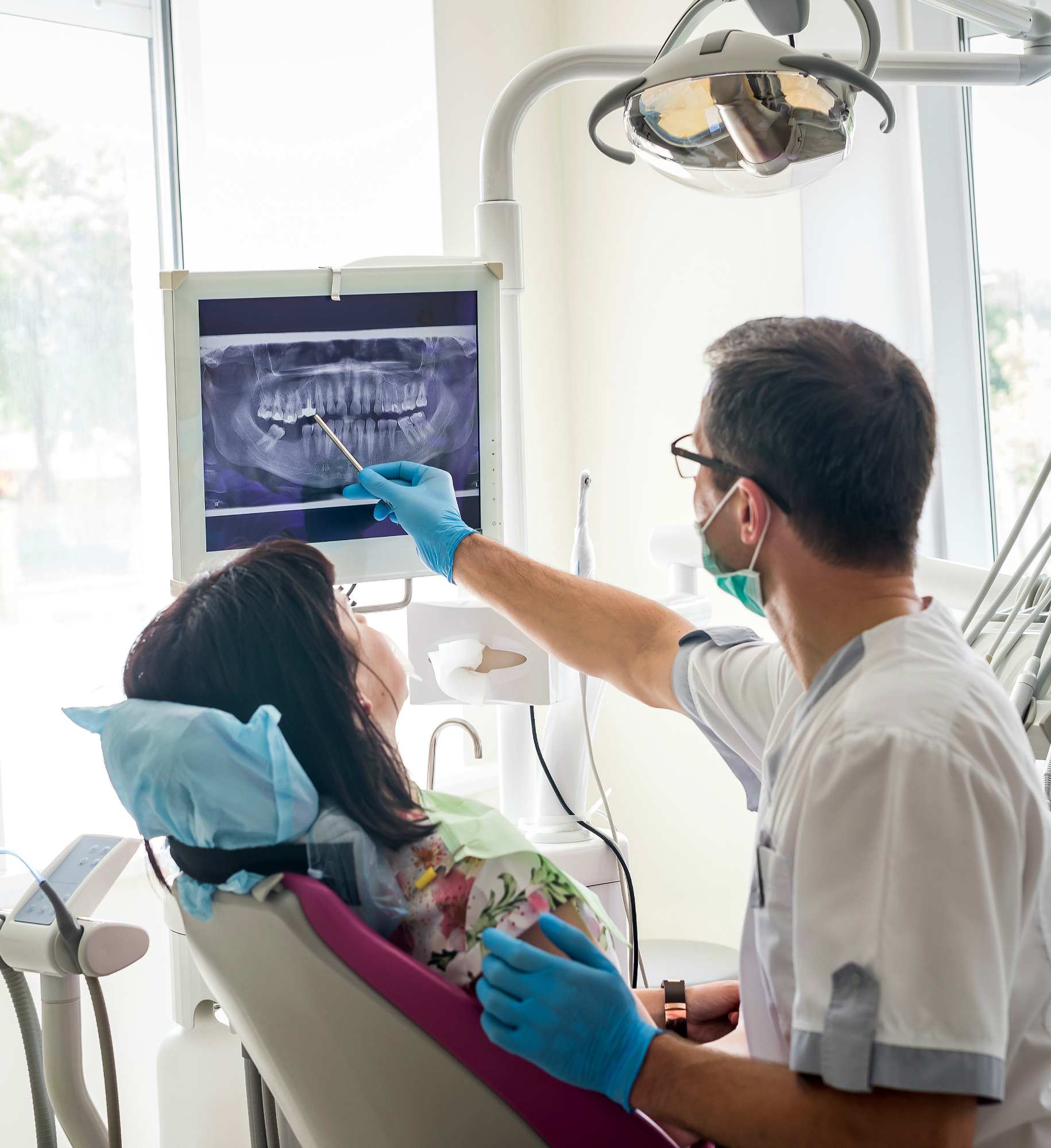 Doctor dentist showing patient's teeth on X-ray