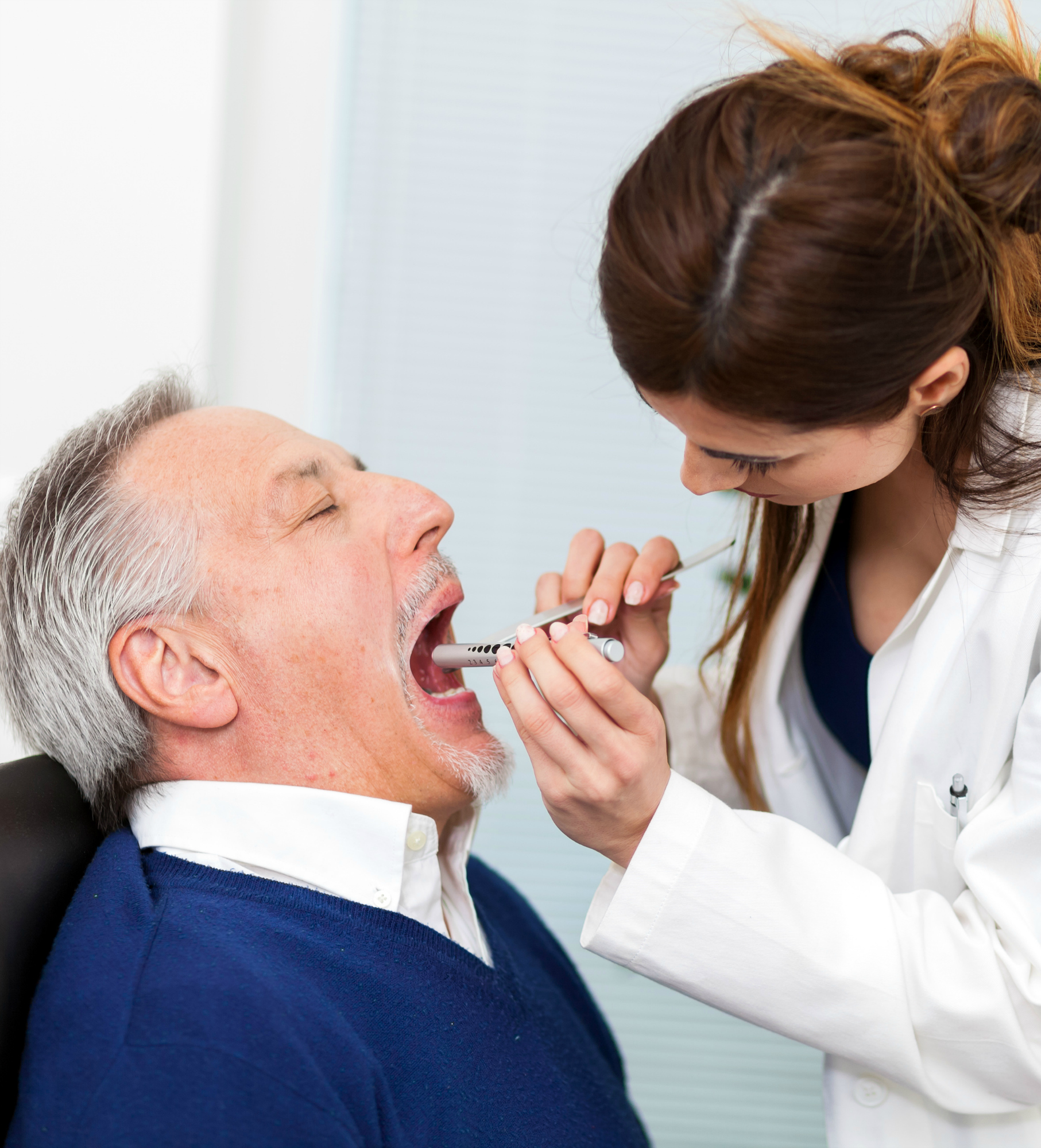 Doctor examining a patient in her office