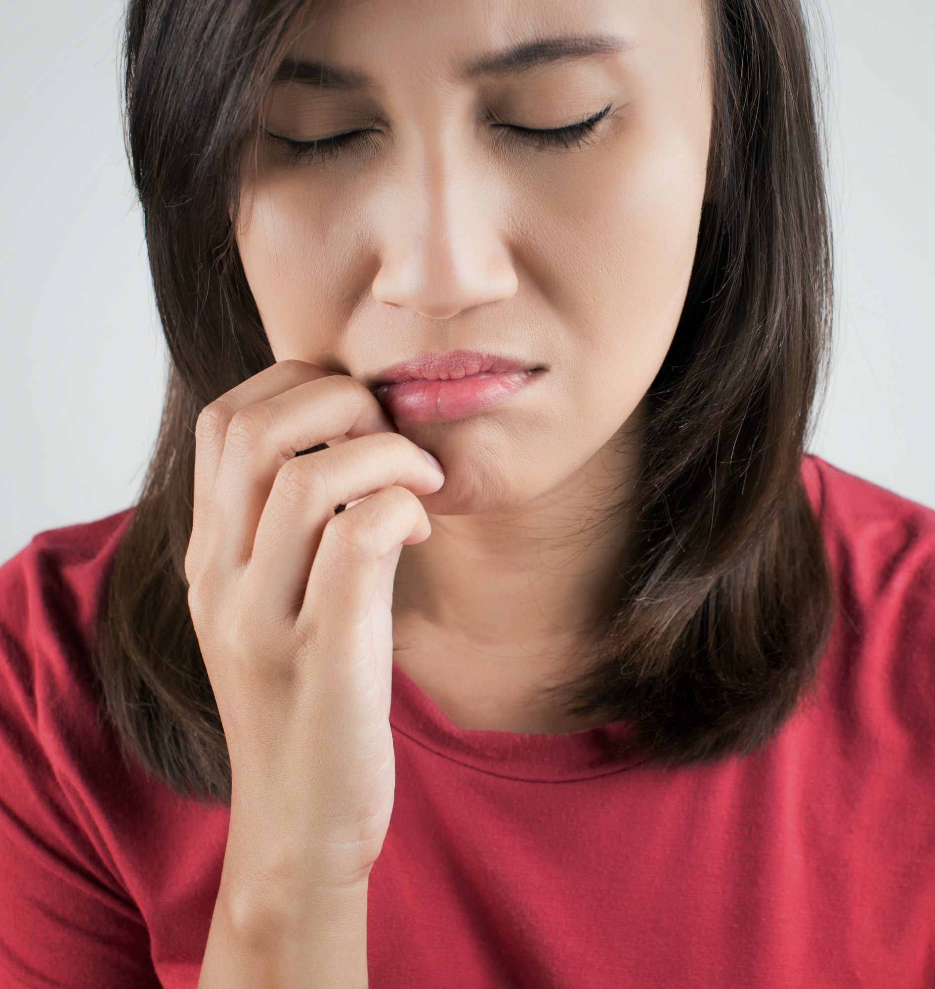 Woman scratching her mouth on white background