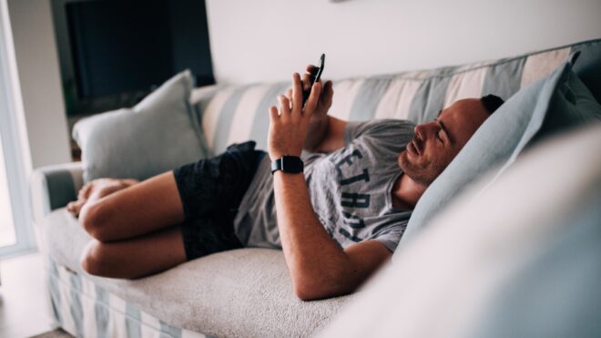 sofa-man-home-smart-phone-couch-laying-down-internet-browsing-mobile-device-smart-watch_t20_xq1aev