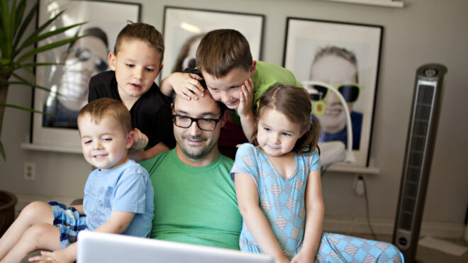 four-kids-sitting-on-dads-lap-and-facetime-chatting-with-grandparents-over-the-internet_t20_qqbaaj