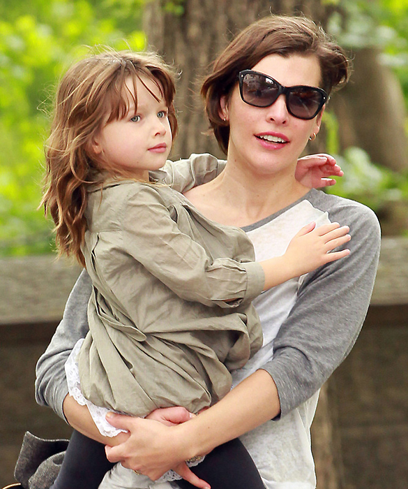 Milla Jovovich, wearing a Beastie Boys t-shirt, looks to be having a great time with daughter Ever while out on 5th Avenue in NYC